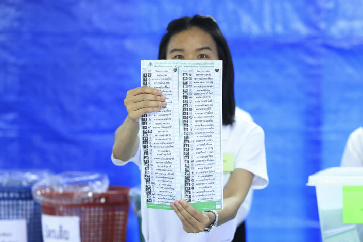 A Thai officer shows a ballot during vote counting at polling station in Bangkok, Thailand, Sunday, May 14, 2023. Vote counting was underway Sunday in Thailand's general election, touted as a pivotal chance for change nine years after incumbent Prime Minister Prayuth Chan-ocha first came to power in a 2014 coup. (AP Photo/Rapeephat Sitichailapa)
