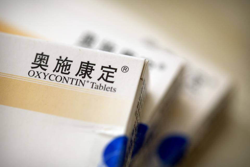 Boxes of OxyContin tablets sold in China sit on a table in southern China's Hunan province on Sept. 24, 2019. Representatives from the Sacklers' Chinese affiliate, Mundipharma, tell doctors that OxyContin is less addictive than other opioids — the same pitch that their U.S. company, Purdue Pharma, admitted was false in court more than a decade ago. (AP Photo/Mark Schiefelbein)