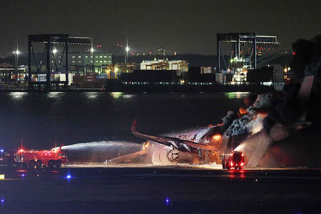 <p>STR/JIJI PRESS/AFP via Getty Images</p> Japan Airlines plane on a runway of Tokyo's Haneda Airport on January 2, 2024