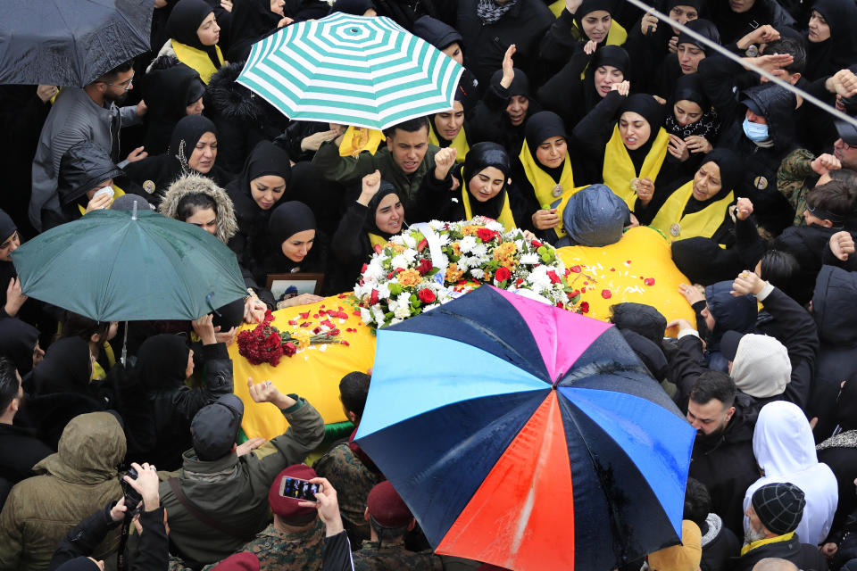 Relatives of Hezbollah senior commander Ali Dibs who was killed by an Israeli airstrike Wednesday night, mourn over his coffin during his funeral procession, in Nabatiyeh town, south Lebanon, Friday, Feb. 16, 2024. Israel's military said it killed a senior commander with the militant Hezbollah group's elite Radwan Force, Ali Dibs, who it says played a role in an attack inside Israel last year that unnerved Israelis, as well as other attacks directed at Israel over the past four months. (AP Photo/Mohammed Zaatari)