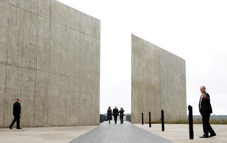 U.S. President Donald Trump and first lady Melania Trump walk with park superintendent Stephen Clark at the Flight 93 National Memorial during the 17th annual September 11 observance at the memorial near Shanksville, Pennsylvania, U.S., September 11, 2018. Reuters photographer Kevin Lamarque: "A somber moment, this image came together because of the scale and symmetry of the wall panels and the people in the photo." REUTERS/Kevin Lamarque