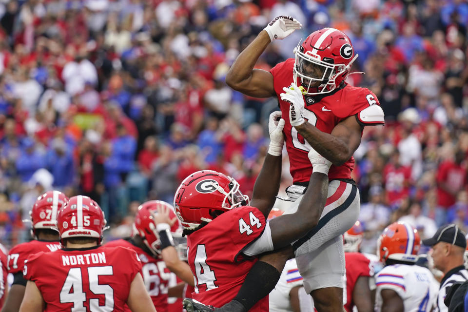 Georgia running back Kenny McIntosh, right, celebrates with teammate tight end Cade Brock (44) after scoring a touchdown against Florida during the first half of an NCAA college football game Saturday, Oct. 29, 2022, in Jacksonville, Fla. (AP Photo/John Raoux)