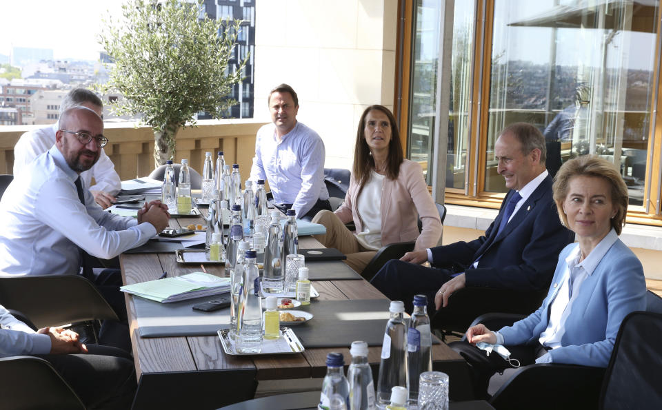 from left, European Council President Charles Michel, Luxembourg's Prime Minister Xavier Bettel, Belgium's Prime Minister Sophie Wilmes, Ireland's Prime Minister Micheal Martin and European Commission President Ursula von der Leyen meet on the sidelines of an EU summit at the European Council building in Brussels, Sunday, July 19, 2020. Leaders from 27 European Union nations meet face-to-face for a third day of an EU summit to assess an overall budget and recovery package spread over seven years estimated at some 1.75 trillion to 1.85 trillion euros.(Francois Walschaerts, Pool Photo via AP)