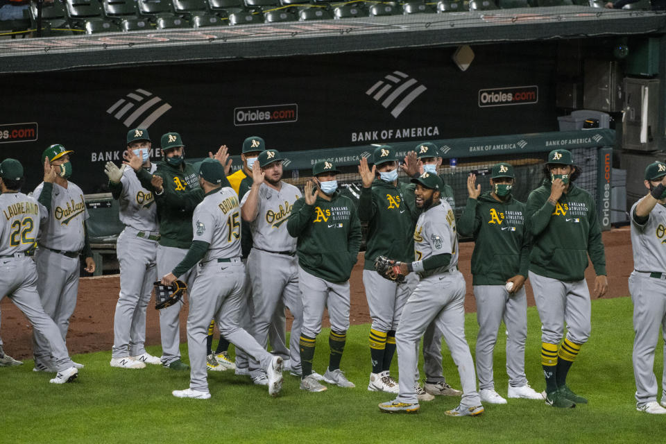 Oakland Athletics gather after a win over the Baltimore Orioles in a baseball game Friday, April 23, 2021, in Baltimore. (AP Photo/Tommy Gilligan)