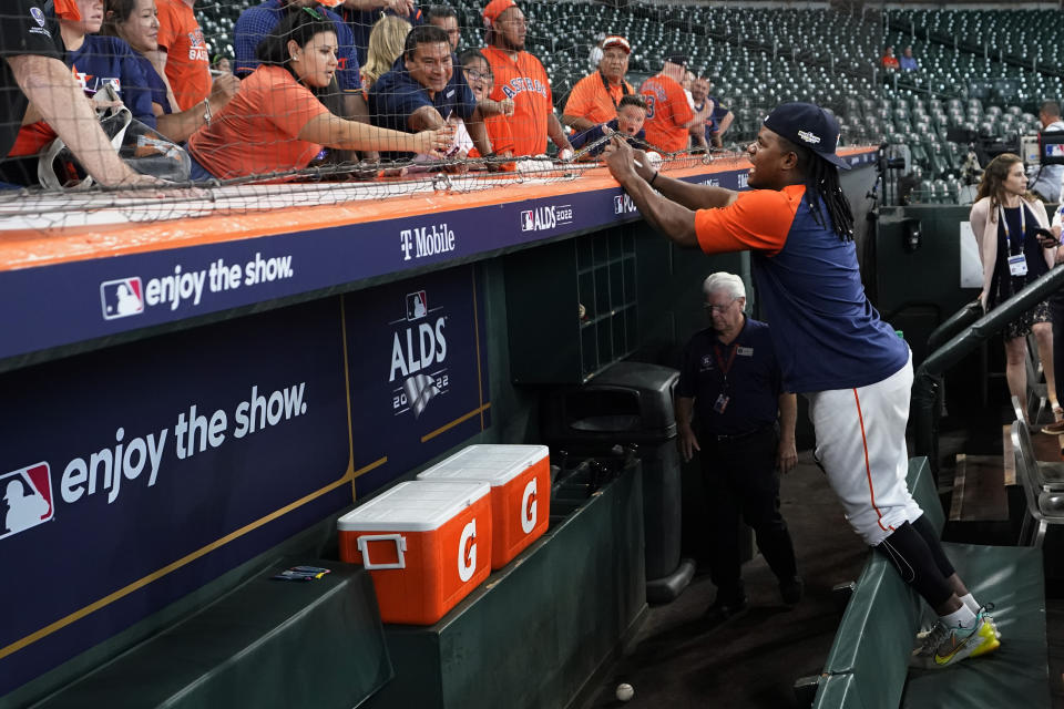 Houston Astros pitcher Framber Valdez signs autographs before Game 1 of an American League Division Series baseball game against the Seattle Mariners in Houston, Tuesday, Oct. 11, 2022. Valdez and teammate Luis Garcia got hair extensions this season and will show off their unique locks this postseason as Houston tries to reach the World Series for the fourth time in six years. (AP Photo/David J. Phillip)