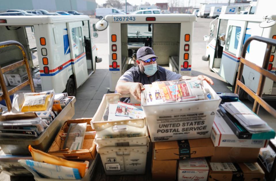 Mail carrier Tony Sobony, 43, loads his delivery truck with mail and packages on the loading dock behind the South Columbus branch of the United States Postal Service on Wednesday, March 10, 2021. Sobony, whose route covers the Alum Creek Drive stretch of South Side, has been a mail carrier for 21 years.