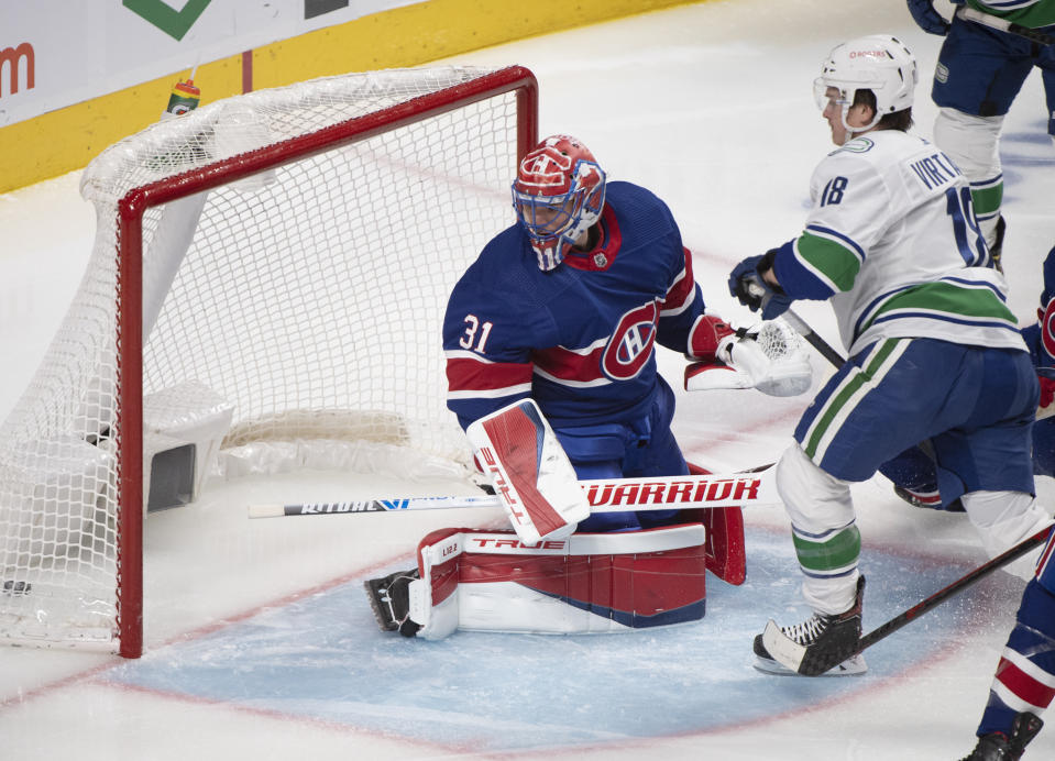 Vancouver Canucks' Jake Virtanen scores against Montreal Canadiens goaltender Carey Price during the second period of an NHL hockey game Saturday, March 20, 2021, in Montreal. (Graham Hughes/The Canadian Press via AP)