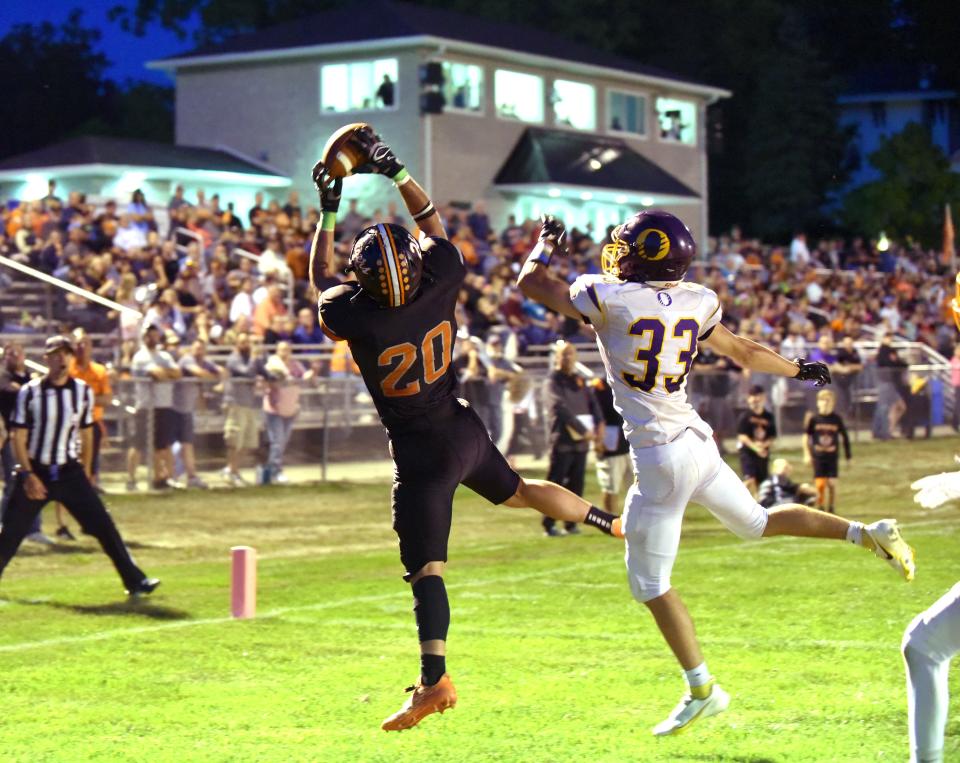Hudson's Logan Ryan hauls in a 2-point conversion against Onsted's Aidan Paquin during Friday's game in Hudson.