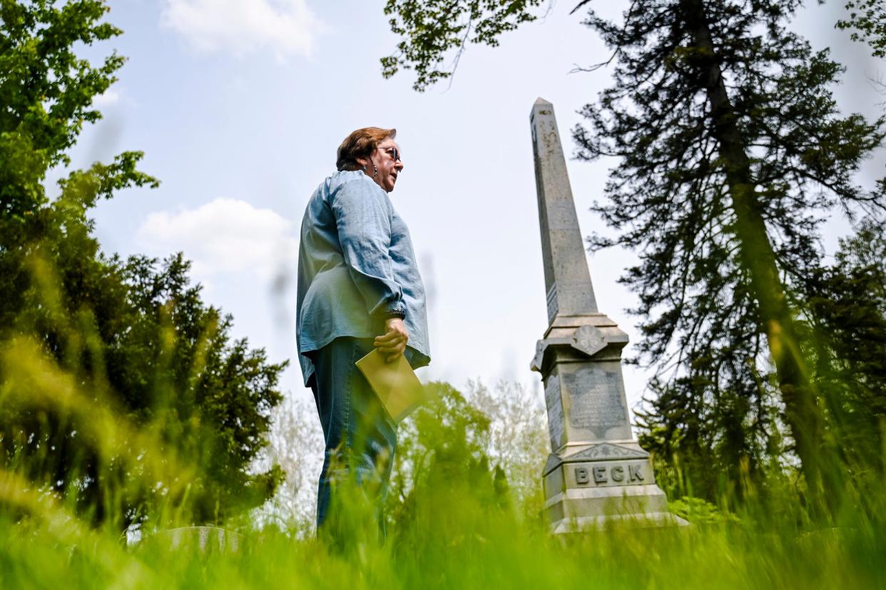 Friends of Lansing's Historic Cemeteries president Loretta Stanaway talks about the two grave markers planned to be restored at the Beck family burial plot on Tuesday, May 23, 2023, at Mt. Hope Cemetery in Lansing.