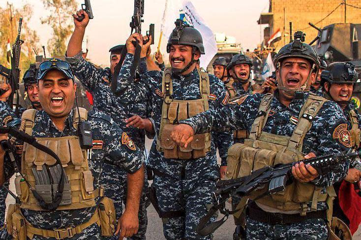 Victory: Iraqi forces celebrate after the liberation of Mosul from Islamic State