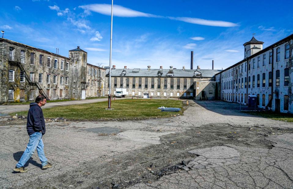 Conversion of mills and other former industrial properties into homes continues in Rhode Island. Here, project manager Christopher Reynolds walks the Cranston Print Works property, where his employer, Brady Sullivan, a Manchester, New Hampshire-based developer, proposes to turn the sprawling and cavernous complex at Cranston and Dyer streets into 129 apartments and 100,000 square feet of self storage. The Cranston Planning Board has given the project initial approval.