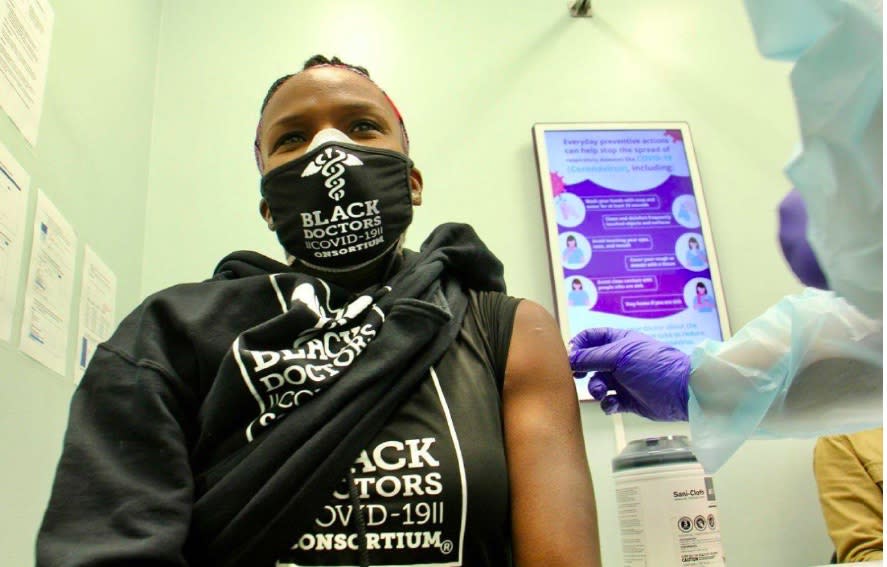 Dr. Ala Stanford receiving her COVID-19 vaccine. Stanford's vaccination was televised in order to promote the safety and efficacy of the shot.<span class="copyright">Emma Lee</span>