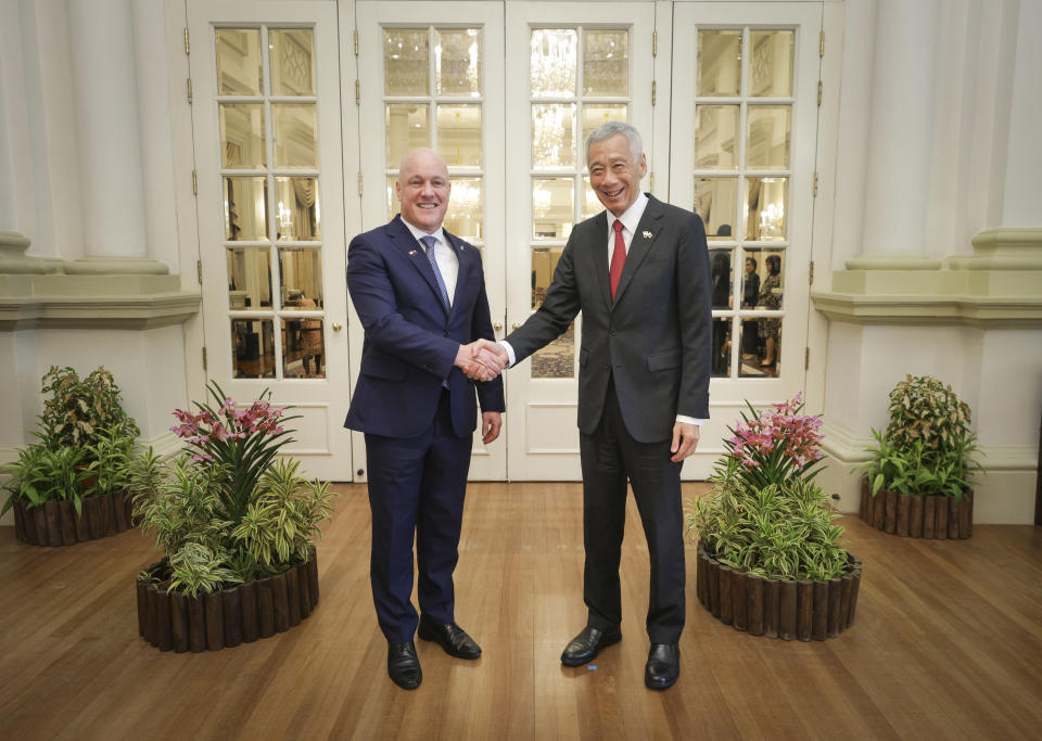 In this photo released by Singapore's Ministry of Communications and Information, New Zealand Prime Minister Luxon, left, shakes hands with Singapore's Prime Minister Lee Hsien Loong at the Istana, Monday, April 15, 2024. (Terence Tan/Ministry of Communications and Information via AP)