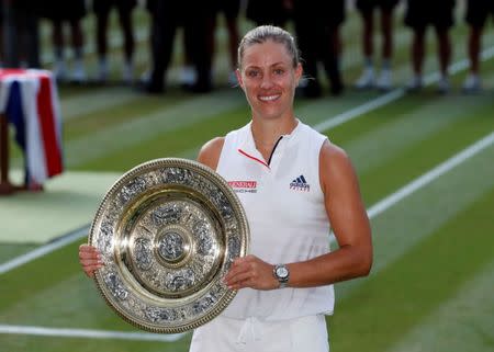 Tennis - Wimbledon - All England Lawn Tennis and Croquet Club, London, Britain - July 14, 2018 Germany's Angelique Kerber celebrates winning the women's singles final with the trophy REUTERS/Andrew Boyers