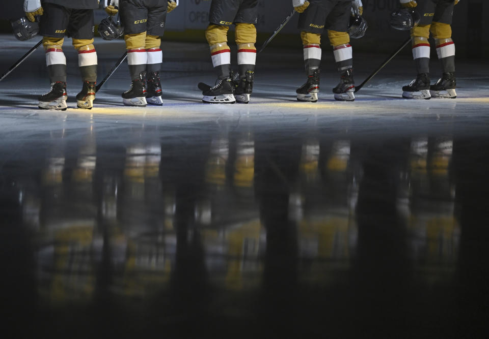 The Vegas Golden Knights stand for the national anthem before an NHL hockey game against the St. Louis Blues on Saturday, May 8, 2021, in Las Vegas. (AP Photo/David Becker)