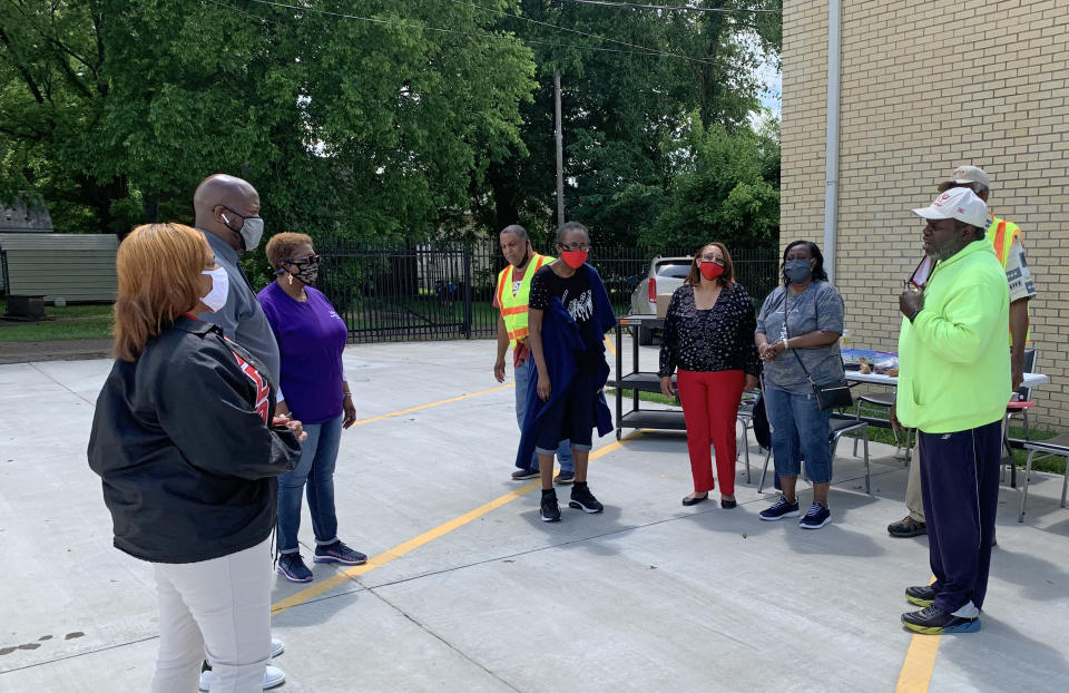 Thaddeus Williams, right, pastor of Tulane Baptist Church, talks outside of a vaccination event in the congregation's parking lot in Yazoo, Miss. (Bracey Harris / NBC News)