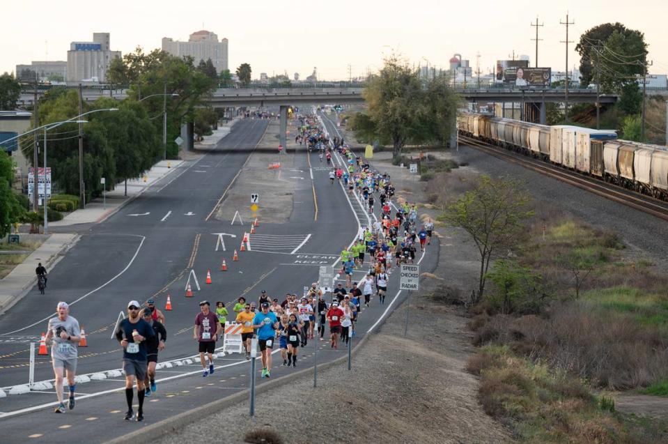 Runners make their way up 9th Street during the Modesto Marathon in Modesto, Calif., on Sunday, March 27, 2022.