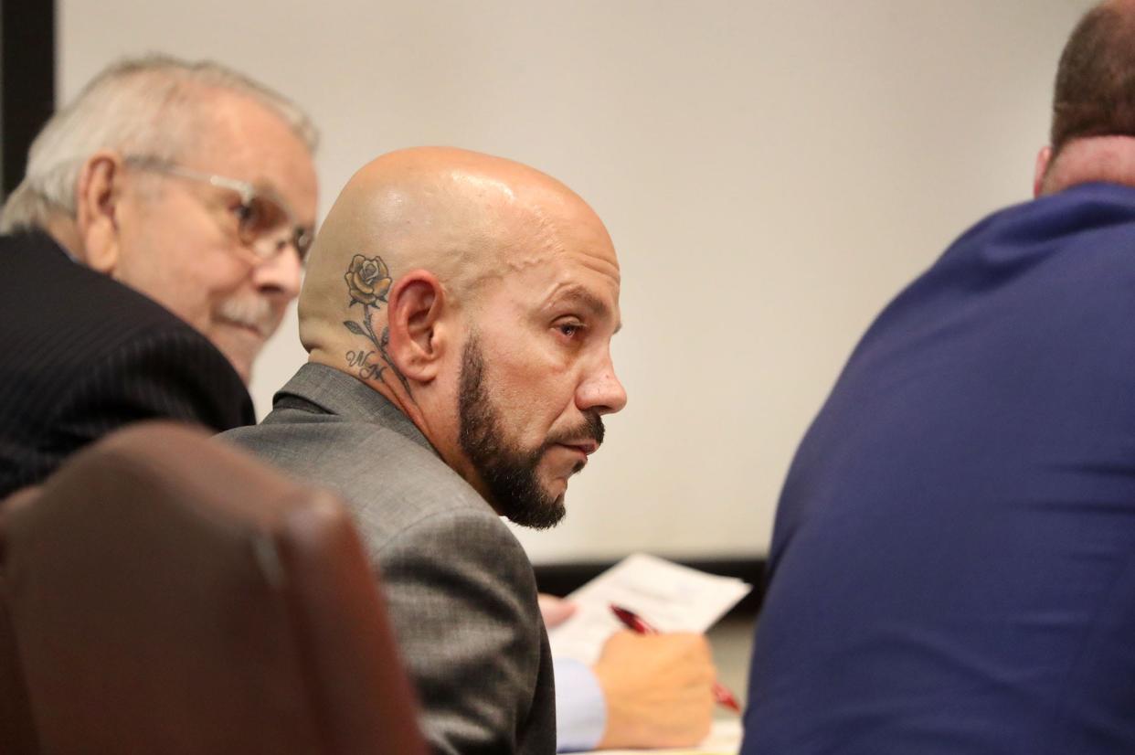 Jason Minton sits with his attorneys, Flem Whited, left, and Aaron Delgado, Tuesday, March 28, 2023, during his trial on three counts of failure to register as a sex offender.