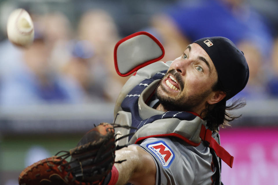 Cleveland Guardians catcher Austin Hedges reaches for but is unable to catch a foul ball hit by Kansas City Royals' Hunter Renfroe during the sixth inning of a baseball game in Kansas City, Mo., Friday, June 28, 2024. (AP Photo/Colin E. Braley)