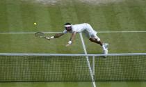 Argentina's Juan Martin Del Potro dives for the ball in his match against Serbia's Novak Djokovic during day eleven of the Wimbledon Championships at The All England Lawn Tennis and Croquet Club, Wimbledon.