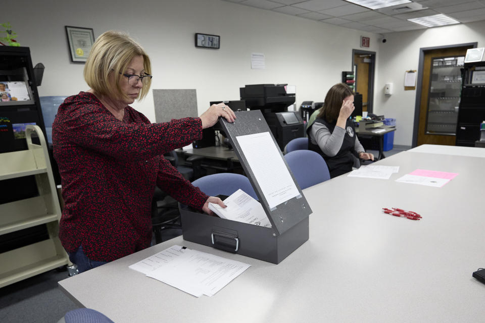 Marie Stevenson Mason County election superintendent, places the scanned test ballots in a box that will be sealed during the logic and accuracy test that is done in all Washington counties, Thursday, Oct. 13, 2022, in Shelton, Wash. (AP Photo/John Froschauer)