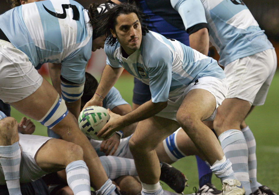 FILE - In this Friday, Oct. 19, 2007 file photo, Argentina's captain Agustin Pichot passes the ball during the Rugby World Cup third place match between France and Argentina, at the Parc des Princes stadium in Paris. Bill Beaumont and Agustin Pichot are vying to become chairman of World Rugby amid trying times for the sport because of the coronavirus outbreak and the growing discussion about a global calendar to unify the international game. (AP Photo/Christophe Ena, File)