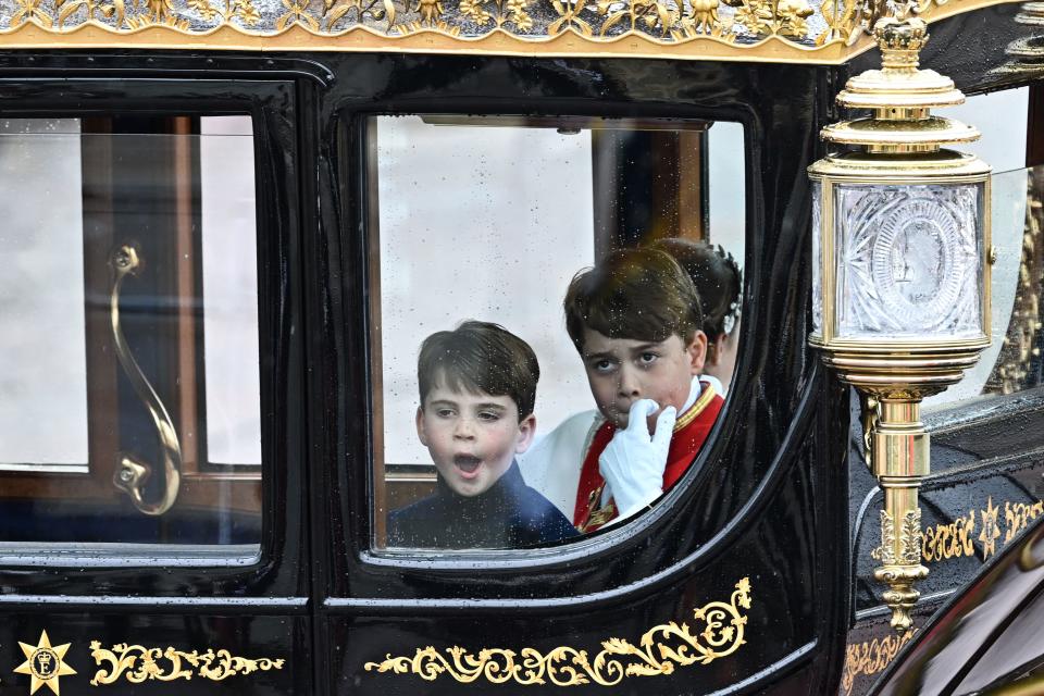<p>Britain's Prince Louis of Wales, Britain's Prince George of Wales and Britain's Princess Charlotte of Wales (hidden) travel back to Buckingham Palace from Westminster Abbey in central London on May 6, 2023, after the coronations of Britain's King Charles III and Britain's Queen Camilla. - The set-piece coronation is the first in Britain in 70 years, and only the second in history to be televised. Charles will be the 40th reigning monarch to be crowned at the central London church since King William I in 1066. (Photo by Oli SCARFF / AFP) (Photo by OLI SCARFF/AFP via Getty Images)</p> 
