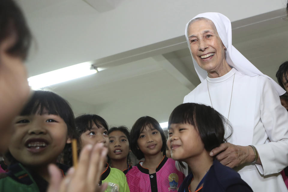 In this Aug. 27, 2019, photo, ST. Mary's School Vice Principal Sister Ana Rosa Sivori, right, talks to students during a lunch break at the girls' school in Udon Thani, about 570 kilometers (355 miles) northeast of Bangkok, Thailand. Sister Ana Rosa Sivori, originally from Buenos Aires in Argentina, shares a great-grandfather with Jorge Mario Bergoglio, who, six years ago, became Pope Francis. So, she and the pontiff are second cousins. (AP Photo/Sakchai Lalit)