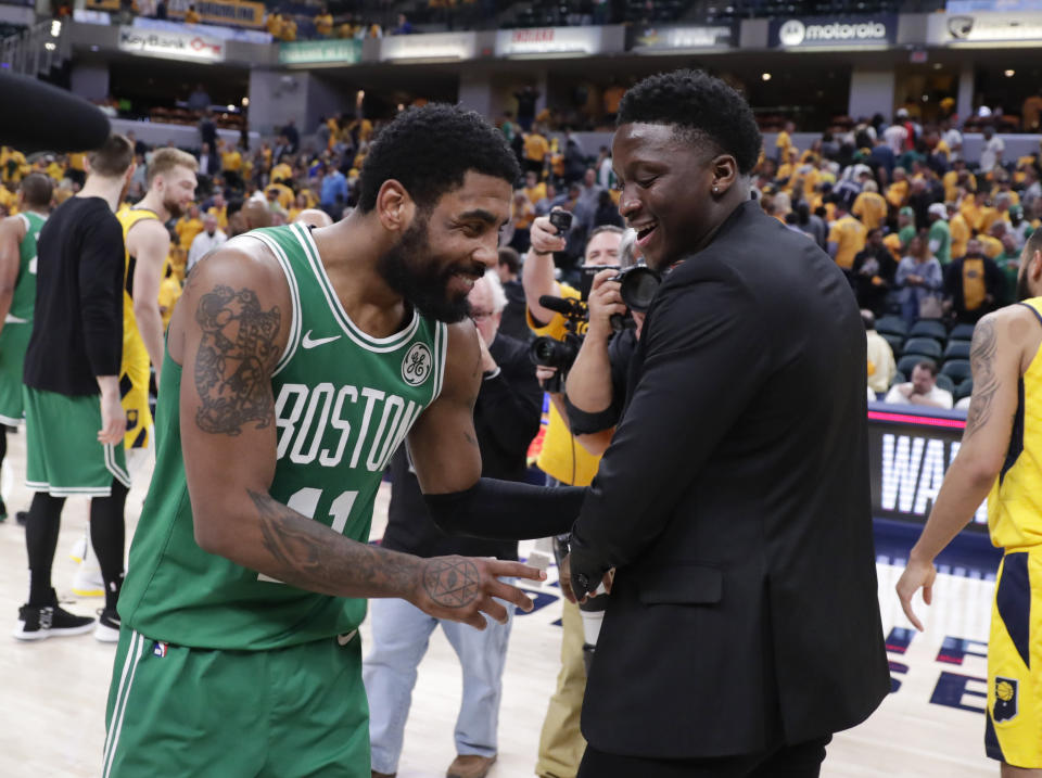 Boston Celtics guard Kyrie Irving (11) isa congratulated by injured Indiana Pacers guard Victor Oladipo (4) following Game 4 of an NBA basketball first-round playoff series in Indianapolis, Sunday, April 21, 2019. The Celtics defeated the Pacers 110-106 to win the series 4-0. (AP Photo/Michael Conroy)