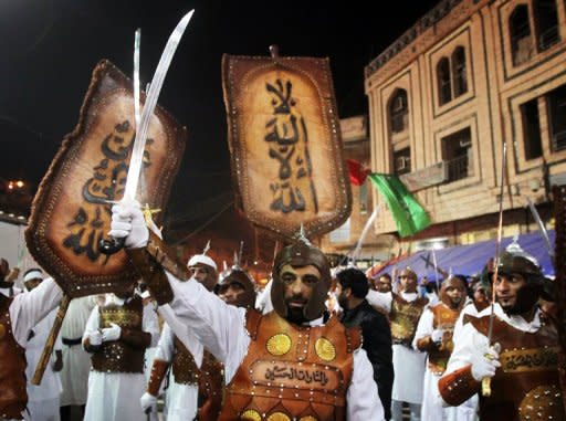 Shiite Muslims gather outside the shrine of Imam Abbas in Karbala early on Sunday. Millions of Shiites flooded the Iraqi shrine city of Karbala for the peak of Ashura rituals on Sunday, which have been largely spared the deadly attacks which struck pilgrims in past years