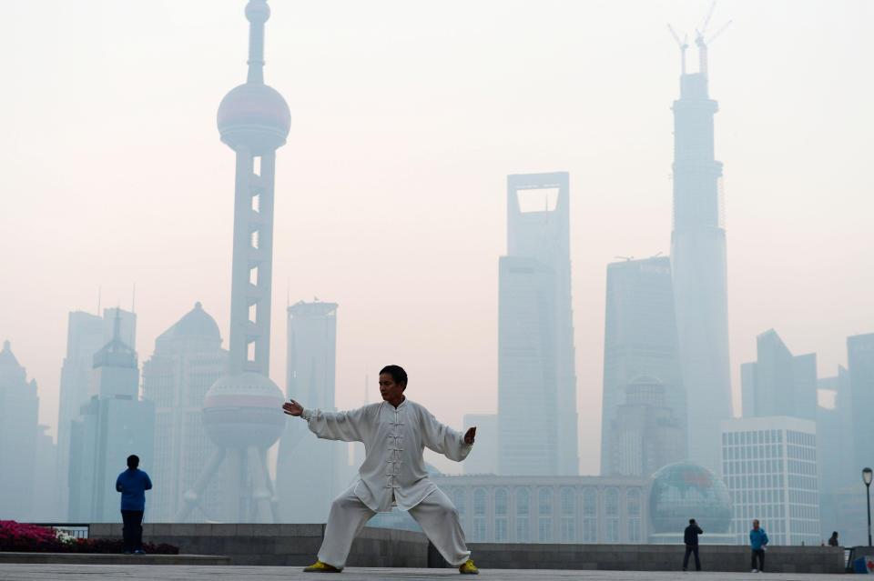 SHANGHAI, CHINA - NOVEMBER 07:  (CHINA OUT) A man practices Tai Chi at the Bund as heavy smog engulfs the city on November 7, 2013 in Shanghai, China. People were advised to stay indoors today as the Shanghai Environment Agency measured air pollution levels at five out of a possible six.  (Photo by ChinaFotoPress/ChinaFotoPress via Getty Images)