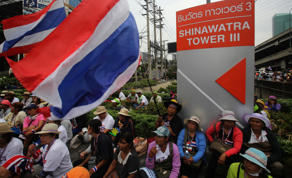 An ant-government protesters gathering outside Shin building from SC Asset building in Bangkok, Thailand, Friday, Feb. 21, 2014. The SC Asset and Shin buildings are owned by the family of embattled Prime Minister Yingluck Shinawatra, whom anti-government protesters are attempting to oust during demonstrations that have lasted for three months. (AP Photo/Sakchai Lalit)