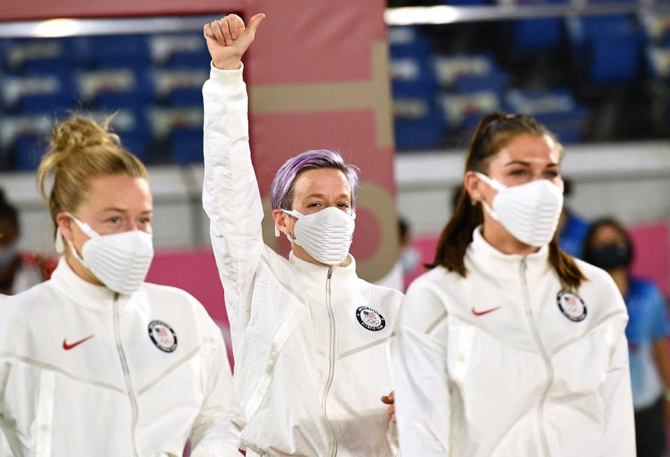 Bronze medallist Megan Rapinoe (pictured middle) waves during the victory ceremony after the Tokyo 2020 Olympic Games.