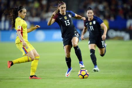 November 13, 2016; Carson, CA, USA; USA forward Alex Morgan (13) moves the ball against Romania defender Teodora Meluta (15) during the second half at StubHub Center. Mandatory Credit: Gary A. Vasquez-USA TODAY Sports