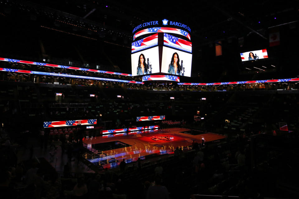 The national anthem is sung before an empty court before the Indiana Fever take on the New York Liberty in a WNBA basketball game, Friday, May 14, 2021, in New York. (AP Photo/Adam Hunger)