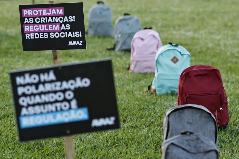 Members of Avaaz, a global web movement, protest in front of National Congress using backpacks to represent victims of school massacres lost due to lack of laws in the virtual world, in Brasilia