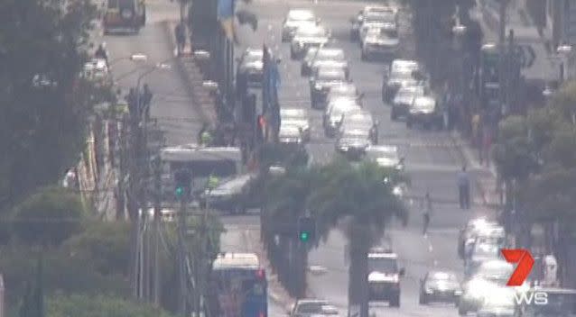 Surrounding streets were closed off as dozens of police officers arrived at the scene. Source: 7 News