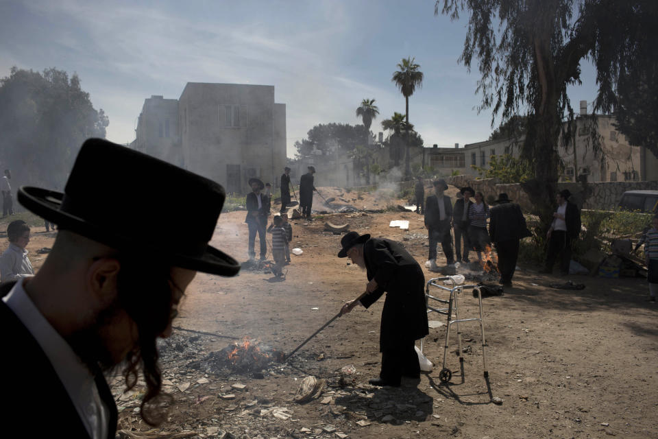 Ultra-Orthodox Jewish men burn leavened items in final preparation for the Passover holiday in the ultra-Orthodox Jewish town of Bnei Brak, near Tel Aviv, Israel, Monday, April 14, 2014. Jews are forbidden to eat leavened foodstuffs during the Passover holiday that celebrates the biblical story of the Israelites' escape from slavery and exodus from Egypt. (AP Photo/Oded Balilty)