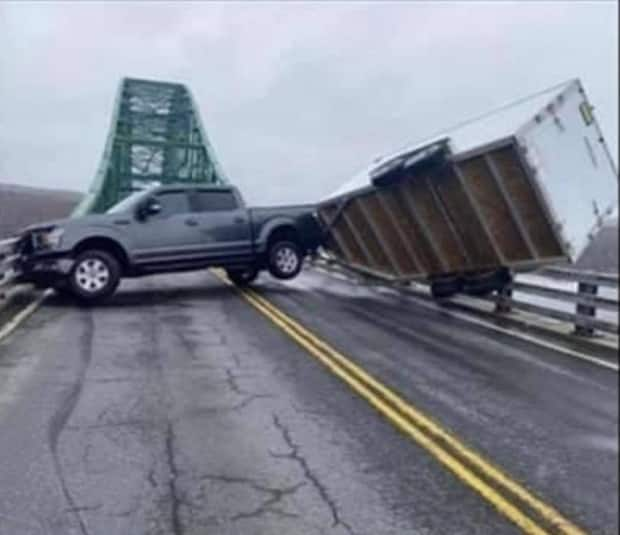 RCMP say high winds caused a pickup truck and trailer has become stuck on the Seal Island Bridge.  (Submitted by Rhonda Lockhart - image credit)