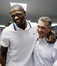 Kentucky's Julius Randle, left, and his former AAU coach Kenny Troutt embrace after Randle announced he will enter his name in the NBA draft during a news conference in Lexington, Ky., Tuesday, April 22, 2014. (AP Photo/James Crisp)