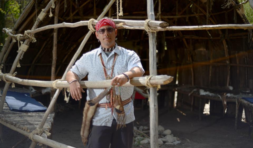 Mashpee Wampanoag Tribe member Marcus Hendricks stands next to a wetu he is making on the grounds of the Historical Society of Old Yarmouth. Hendricks questions an Indigenous peoples walking tour held by the Brewster Historical Society, saying no Indigenous people are involved.