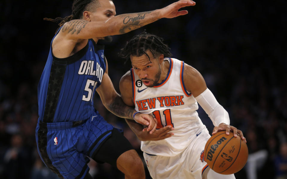 New York Knicks guard Jalen Brunson (11) dribbles past Orlando Magic guard Cole Anthony, left, during the second half of an NBA basketball game Monday, Oct. 24, 2022, in New York. (AP Photo/John Munson)