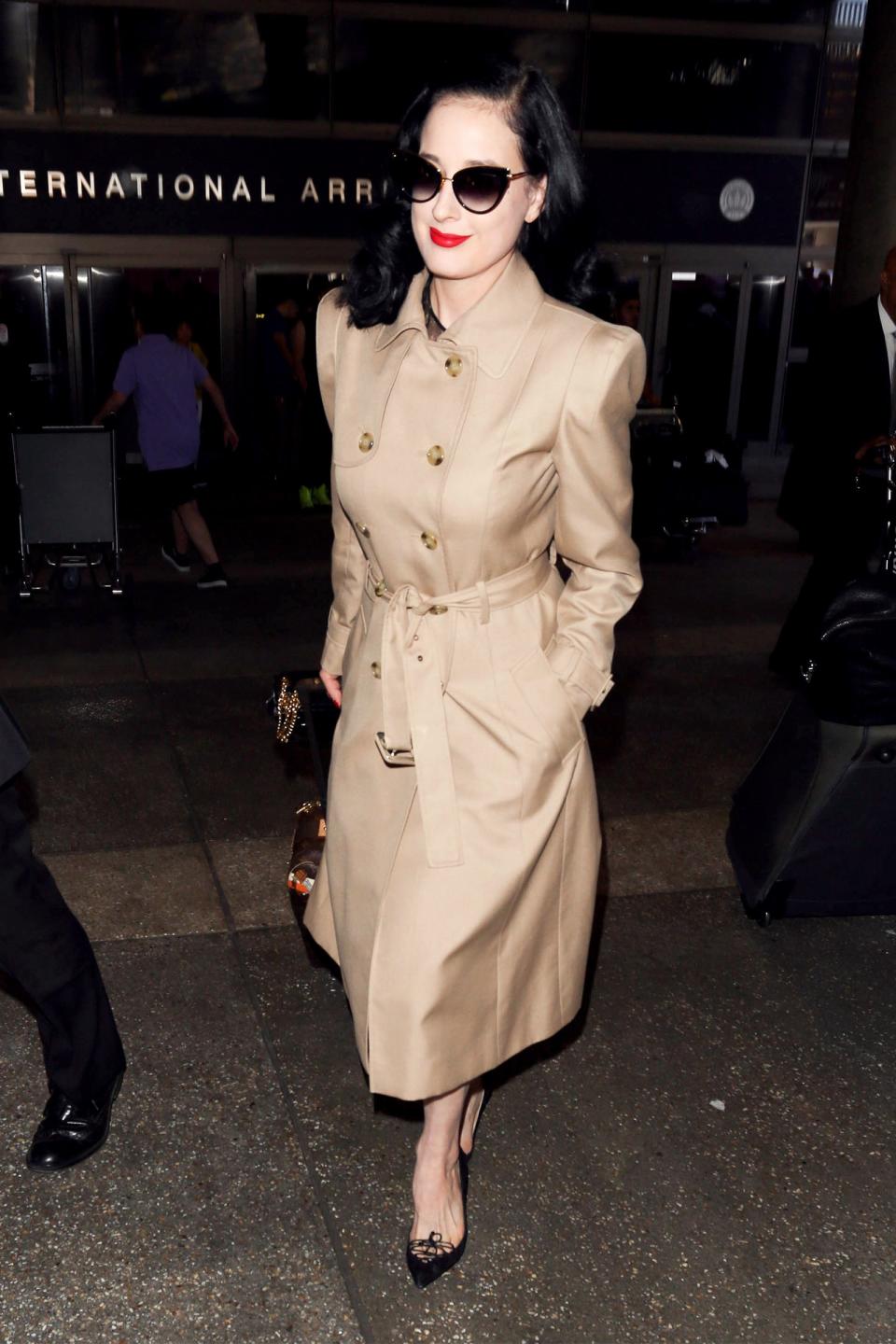 For a retro-inspired travel look, try a belted trench coat and pointy flats.