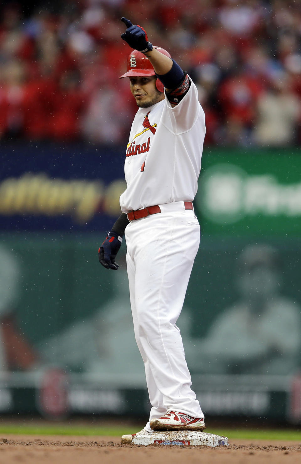 St. Louis Cardinals' Yadier Molina celebrates on second after hitting a three-run double during the first inning of a baseball game against the Cincinnati Reds, Monday, April 7, 2014, in St. Louis. (AP Photo/Jeff Roberson)