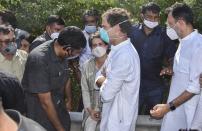 India’s opposition Congress party leaders, Rahul Gandhi, center and his sister Priyanka Gandhi pause after they are stopped by police on a highway in Gautam Buddha Nagar, Uttar Pradesh state, Thursday, Oct. 1, 2020. Indian police detained the leaders after preventing them from visiting a village where a 19-year-old woman from India's lowest caste was gang raped last month and later died in a hospital. (AP Photo/Dinesh Joshi)