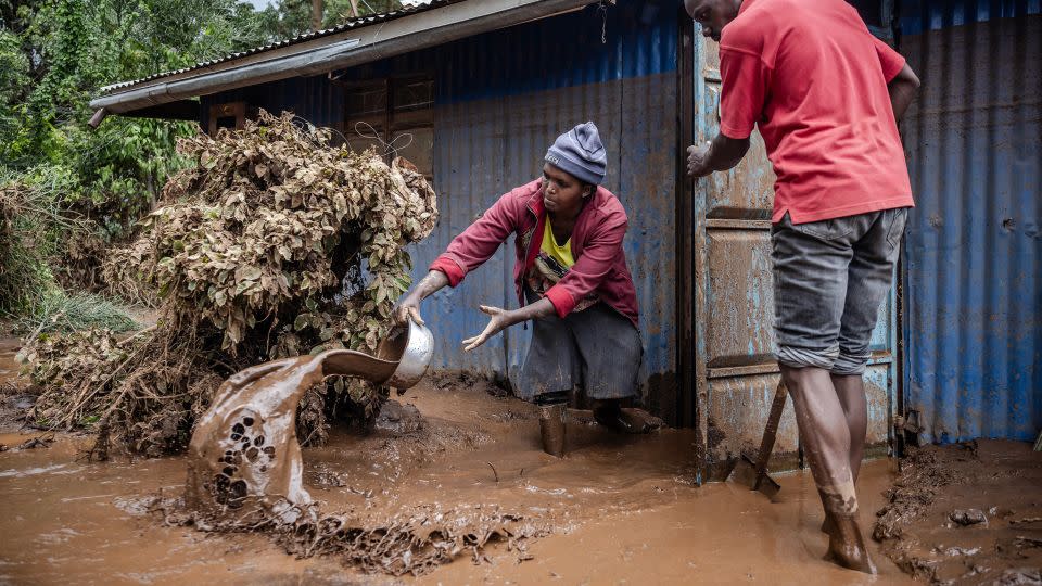 People removing mud and water from their house in Mai Mahiu, Kenya, on April 29. - Luis Tato/AFP via Getty Images