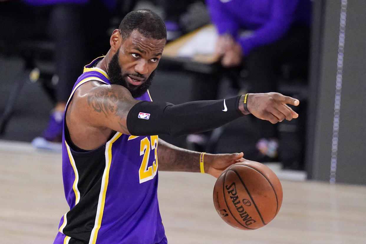 LeBron James intensely dribbles a basketball.