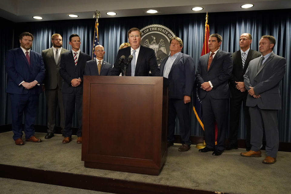 Flanked by various statewide hospital administrators, Mississippi Gov. Tate Reeves, center, announces a proposal that he says should alleviate financial problems for hospitals, during a news conference Thursday, Sept. 21, 2023, in Jackson, Miss. (AP Photo/Rogelio V. Solis)