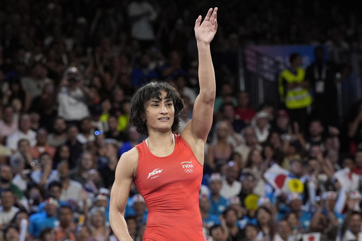 India's Vinesh Phogat celebrates after defeating Cuba's Yusneylys Guzman during their women's freestyle 50kg wrestling semifinal match, at Champ-de-Mars Arena, during the 2024 Summer Olympics, Tuesday, Aug. 6, 2024, in Paris, France. (AP Photo/Eugene Hoshiko)