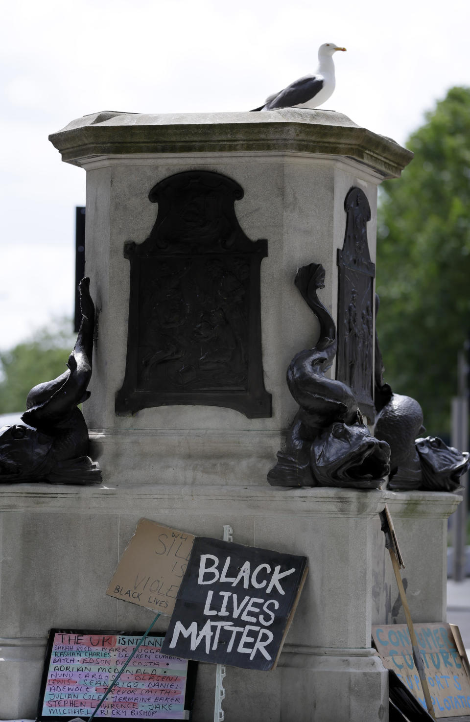 FILE - In this file photo dated Monday, June 8, 2020, a seagull sits on the pedestal of the toppled statue of Edward Colston in Bristol, England. The death of George Floyd at the hands of police and Minneapolis, USA, has sparked a re-examination of injustices and inequalities in the fabric of many societies, often symbolized in statues of historical figures have become the focus of protest around the world. (AP Photo/Kirsty Wigglesworth, FILE)